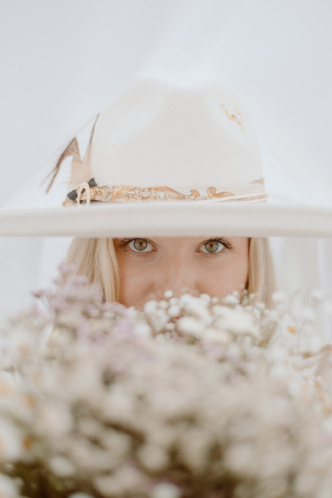 three tips on what outfit to wear for your branding photoshoot for a boho theme using a hat and flowers as an accessory