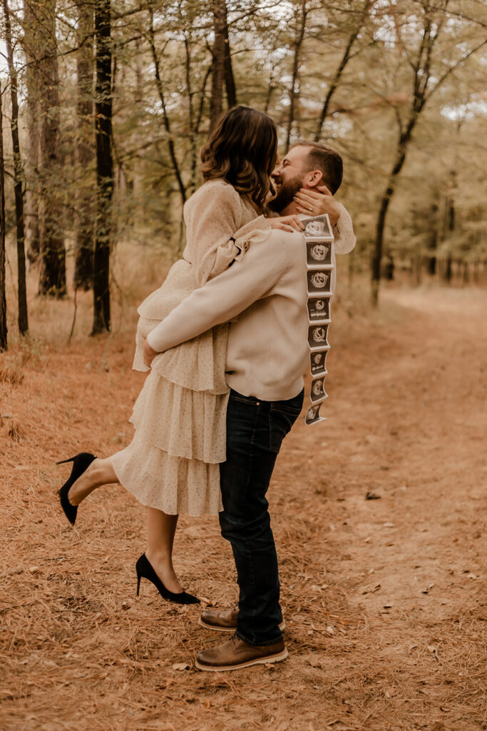 pregnancy announcement photos in a pine tree forest wearing polka dotted outfit 