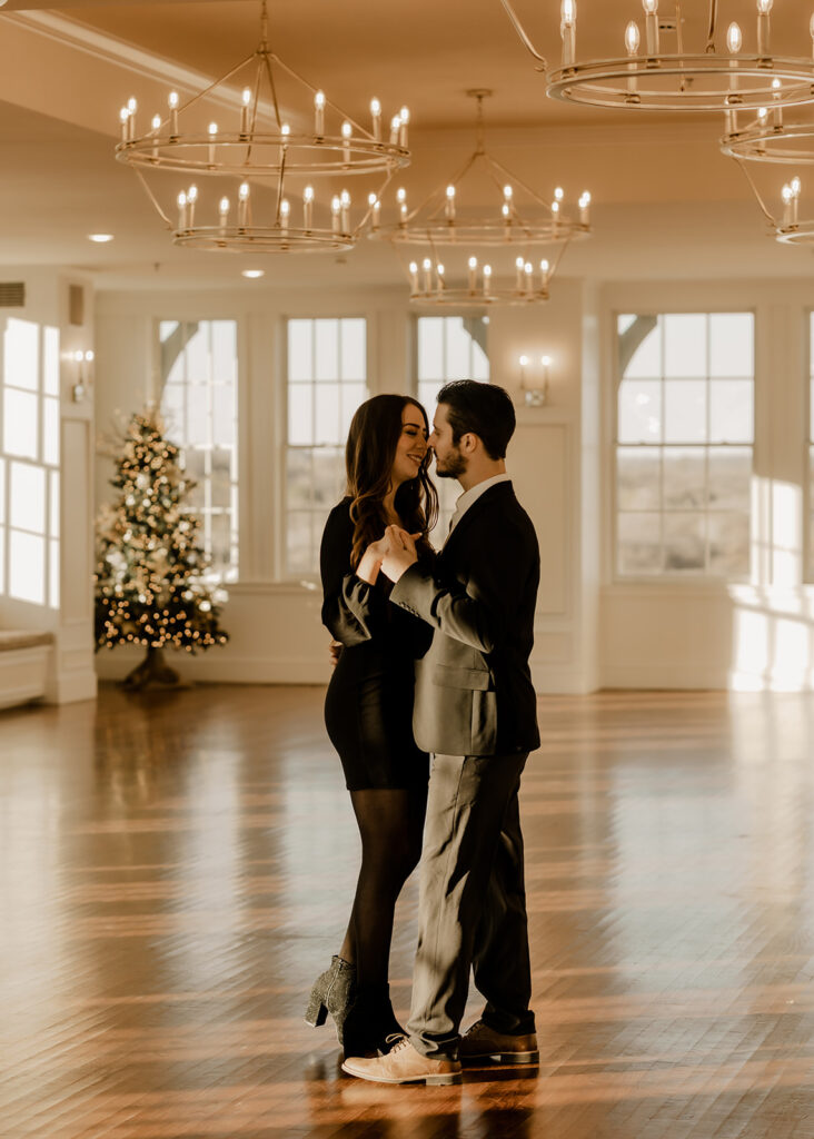 couple dancing in a ballroom during engagement photoshoot