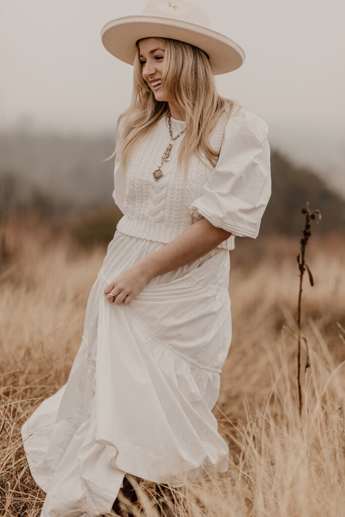 three tips on what outfit to wear for your branding photoshoot for a boho theme and a hat as an accessory taken in a field in fort worth texas