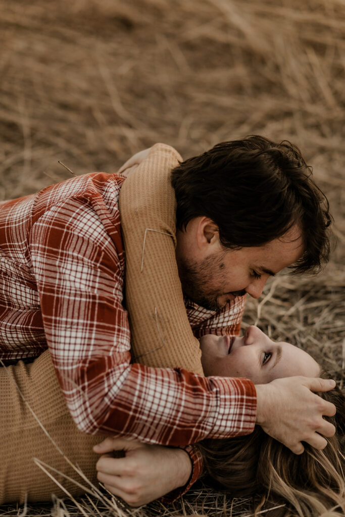 engagement photos at Mineral Wells State Park couple rolling around in grass