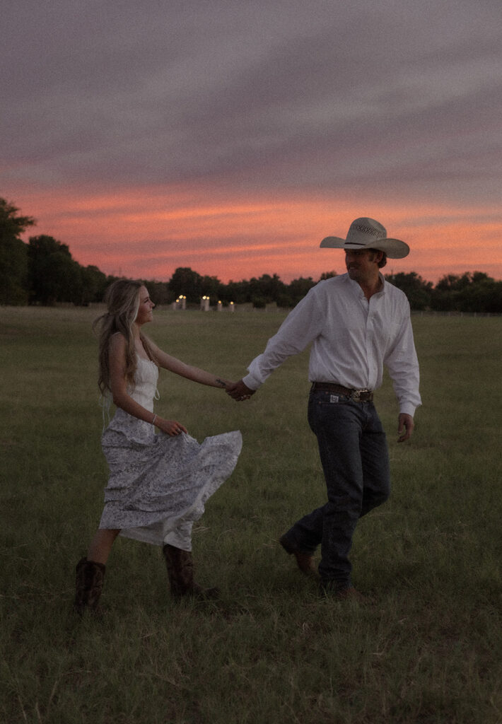 cowboy cowgirl walking engagement session at sunset 